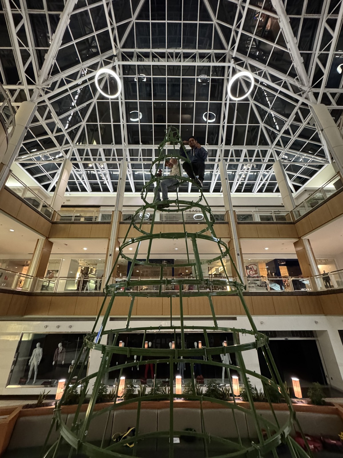 Pug Lights crew building a large Christmas tree frame inside Park Plaza Mall