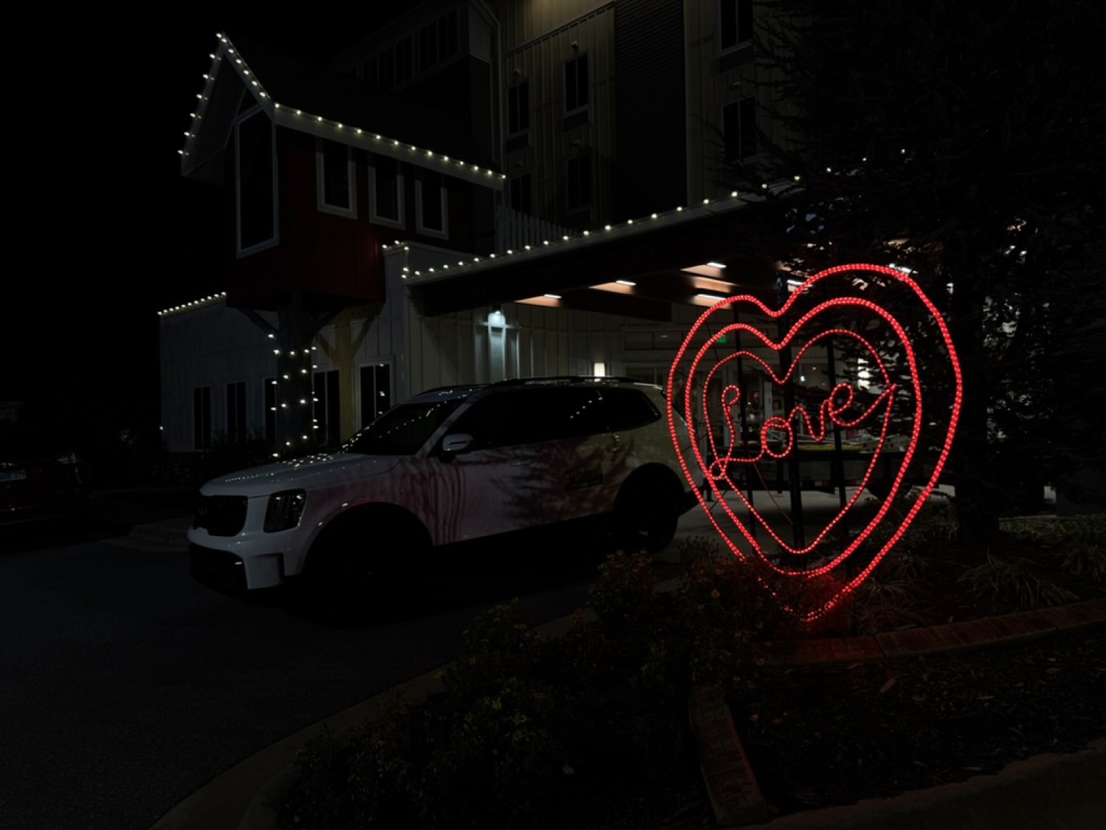 Custom lit heart display reading Love outside a commercial property